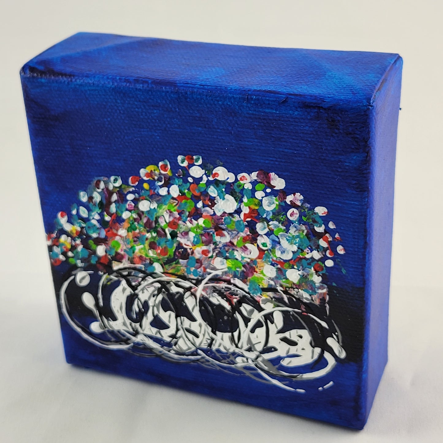 4x4 inch canvas painting with blue background and bold colors