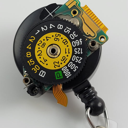 ID BADGE REEL - CANON A-1 SHUTTER SPEED DIAL #004